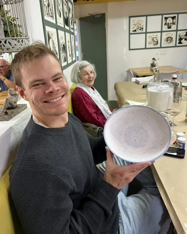 A customer holding his blue speckled bowl