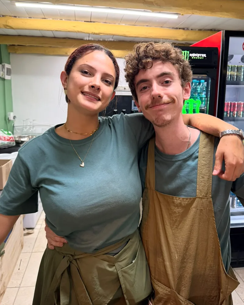 Angie and Josh in their aprons behind the counter at the Mustard Seed Cafe